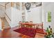 Elegant dining room featuring high ceilings, wood floors, a stylish chandelier and bright windows at 10115 Cook St, Thornton, CO 80229