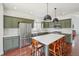 Contemporary kitchen with stainless steel appliances, a large island, and stylish pendant lighting at 10115 Cook St, Thornton, CO 80229