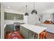 Beautiful kitchen featuring olive-green cabinets, stainless appliances, and a center island with seating at 10115 Cook St, Thornton, CO 80229