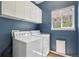 Functional laundry room with full-size washer and dryer, ample cabinet space, and window for natural light at 10115 Cook St, Thornton, CO 80229
