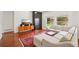 Comfortable living room featuring a fireplace, TV, hardwood floors, and natural light at 10115 Cook St, Thornton, CO 80229