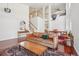 Spacious living room featuring soaring ceilings, hardwood floors, and an open layout with stairs at 10115 Cook St, Thornton, CO 80229