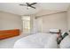 Spacious main bedroom featuring neutral carpet, ceiling fan, and ensuite bathroom with walk in closet at 10115 Cook St, Thornton, CO 80229