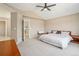 Spacious main bedroom featuring neutral carpet, walk in closet, ceiling fan and large windows at 10115 Cook St, Thornton, CO 80229