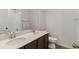 Bathroom featuring double vanity, a large mirror, white subway tile, and modern fixtures at 455 S Salida St, Aurora, CO 80017