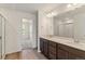 Bright bathroom features a double vanity, modern lighting, and a glass-enclosed shower at 455 S Salida St, Aurora, CO 80017