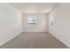 Sunlit bedroom featuring neutral carpet and two windows offering natural light at 455 S Salida St, Aurora, CO 80017