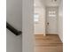 Hallway entryway featuring luxury vinyl plank flooring and a front door with glass window panes at 455 S Salida St, Aurora, CO 80017