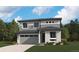 Beautiful two-story home featuring stone accents, gray siding, complemented by professional landscaping and a two car garage at 455 S Salida St, Aurora, CO 80017