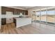 Modern kitchen with island, dark cabinets, stainless appliances, and luxury vinyl plank flooring at 455 S Salida St, Aurora, CO 80017