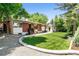 Lush backyard featuring grass, patio, and the exterior view of the home at 7642 S Ames Way, Littleton, CO 80128