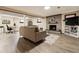 Relaxing basement space featuring a brick fireplace, comfortable seating, and bright lighting at 7642 S Ames Way, Littleton, CO 80128