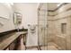Well-lit bathroom showcasing a glass enclosed shower and stylish vanity with a unique design at 7642 S Ames Way, Littleton, CO 80128