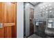 Contemporary bathroom features a glass-enclosed shower with modern fixtures and neutral gray tile at 7642 S Ames Way, Littleton, CO 80128