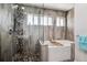 Bathroom featuring walk in shower and stand alone tub at 7642 S Ames Way, Littleton, CO 80128