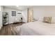 Bright bedroom features a cozy chair, side table, and view of an en-suite bathroom at 7642 S Ames Way, Littleton, CO 80128