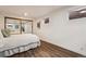 Bedroom features a sliding mirrored closet and bright natural light from the windows at 7642 S Ames Way, Littleton, CO 80128