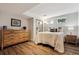 Cozy bedroom features wood floors, a dresser, and a comfortable bed with stylish pillows at 7642 S Ames Way, Littleton, CO 80128