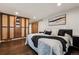 Bedroom featuring a large closet and hardwood floors at 7642 S Ames Way, Littleton, CO 80128