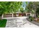 Well-maintained exterior with a wide driveway and attached two-car garage at 7642 S Ames Way, Littleton, CO 80128