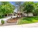 Charming home with mature trees, landscaped front yard, and a long driveway at 7642 S Ames Way, Littleton, CO 80128