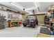 Well-organized garage with work bench and a Jeep at 7642 S Ames Way, Littleton, CO 80128