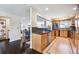 Open concept kitchen with stainless steel appliances and dark backsplash tiles at 7642 S Ames Way, Littleton, CO 80128