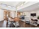 Open-concept living and dining areas with hardwood floors and ample natural light at 7642 S Ames Way, Littleton, CO 80128