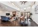 Spacious living room featuring a brick fireplace, vaulted ceilings, and modern furnishings at 7642 S Ames Way, Littleton, CO 80128