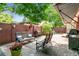 Paver patio with outdoor seating, brick surround, grilling station, and decorative parrot statue at 7642 S Ames Way, Littleton, CO 80128