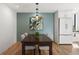 Inviting dining area adjacent to the kitchen, enhanced by a stylish light fixture at 480 S Marion Pkwy # 306, Denver, CO 80209