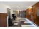 A modern lobby with a wood accent wall, modern tiling, and two plush chairs at 480 S Marion Pkwy # 306, Denver, CO 80209