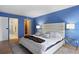 Bright main bedroom with an en-suite bathroom, large bed, and stylish lighting at 480 S Marion Pkwy # 306, Denver, CO 80209