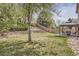 Landscaped backyard featuring a wood fence, tiered retaining wall and a covered seating area at 19131 E Crestridge Cir, Aurora, CO 80015