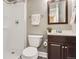 Full bathroom featuring a shower, vanity with dark cabinet and a white toilet at 19131 E Crestridge Cir, Aurora, CO 80015