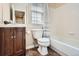 Bathroom featuring a single sink vanity, tile floor and toilet and bathtub with white tile at 19131 E Crestridge Cir, Aurora, CO 80015