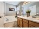 Well-lit bathroom with double sinks, modern lighting, and a separate soaking tub at 19131 E Crestridge Cir, Aurora, CO 80015