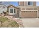 Inviting exterior featuring a well-manicured lawn and a two-car garage at 19131 E Crestridge Cir, Aurora, CO 80015