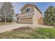 View of a two-story home, showcasing the garage and landscaped front yard at 19131 E Crestridge Cir, Aurora, CO 80015