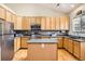Modern kitchen featuring stainless steel appliances and light wood cabinets at 19131 E Crestridge Cir, Aurora, CO 80015