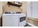 Laundry room featuring modern, front loading washer and dryer, and storage cabinet at 19131 E Crestridge Cir, Aurora, CO 80015