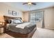 Relaxing main bedroom featuring a ceiling fan, window, and a large comfortable bed at 19131 E Crestridge Cir, Aurora, CO 80015