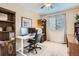 Functional office with a ceiling fan, natural light, built-in bookshelves, and modern desk at 19131 E Crestridge Cir, Aurora, CO 80015