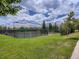 Well-maintained tennis courts in a serene community setting with green lawns and landscaping at 19131 E Crestridge Cir, Aurora, CO 80015