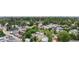 Wide aerial shot of a residential neighborhood with mature trees and a cityscape in the background at 2935 S Sherman St, Englewood, CO 80113