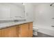 Bright bathroom featuring granite countertop, wooden vanity and white subway tile in shower at 2935 S Sherman St, Englewood, CO 80113