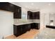 Modern kitchen with sleek, dark cabinetry, granite countertops, and stylish backsplash at 2935 S Sherman St, Englewood, CO 80113