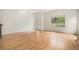 Bright living room featuring hardwood floors, a door with glass, and a large window at 2935 S Sherman St, Englewood, CO 80113