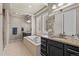 Luxury bathroom with a soaking tub, granite countertops, and double sinks at 15230 W Baker Ave, Lakewood, CO 80228