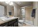 Well-appointed bathroom with modern fixtures, glass shower, and ample countertop space at 15230 W Baker Ave, Lakewood, CO 80228